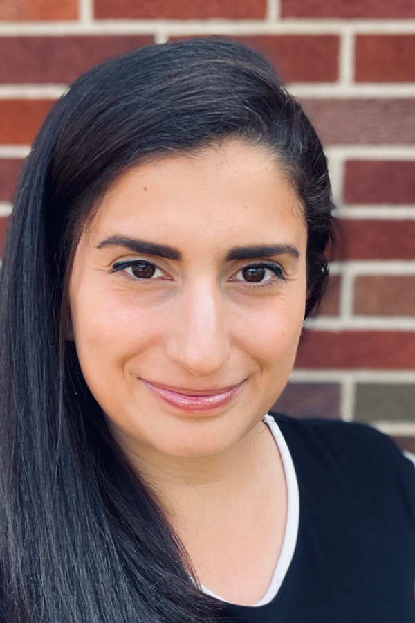 Headshot of Krystel Tossone in front of a brick wall